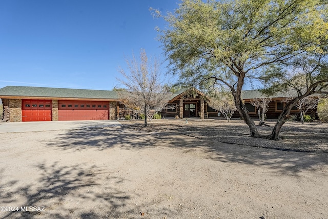 11569 E Speedway Blvd, Tucson, AZ 85748 - view of front of house with dirt driveway and a garage