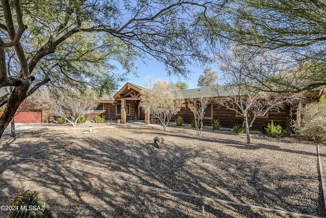 11569 E Speedway Blvd, Tucson, AZ 85748 - view of front facade featuring a porch and log exterior