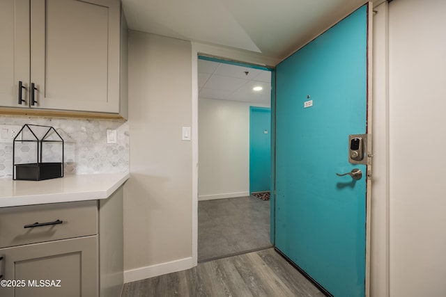 425 W Paseo Redondo Unit 3D, Tucson, AZ 85701 - kitchen featuring backsplash, wood finished floors, light countertops, baseboards, and recessed lighting