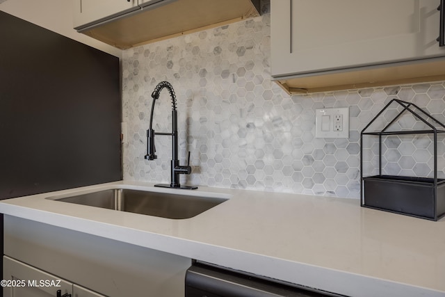 425 W Paseo Redondo Unit 3D, Tucson, AZ 85701 - kitchen view of decorative backsplash, a sink, and light countertops