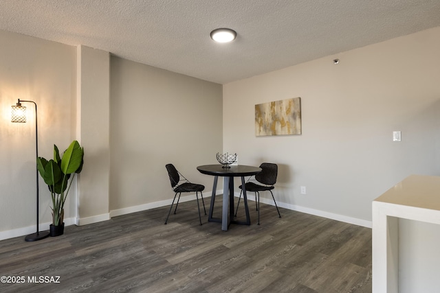 425 W Paseo Redondo Unit 3D, Tucson, AZ 85701 - dining area featuring dark wood-style flooring, a textured ceiling, and baseboards