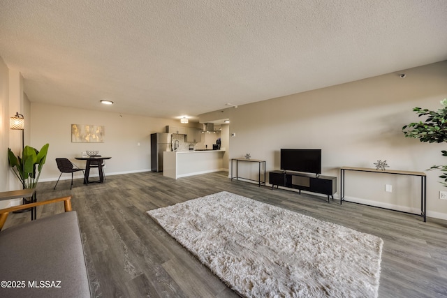 425 W Paseo Redondo Unit 3D, Tucson, AZ 85701 - living area featuring dark wood-style floors, a textured ceiling, and baseboards