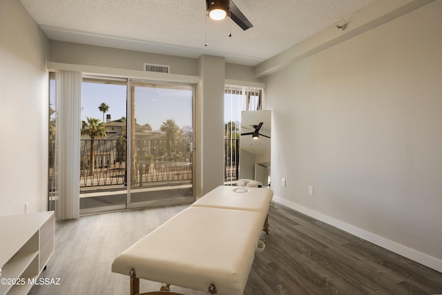 425 W Paseo Redondo Unit 3D, Tucson, AZ 85701 - bedroom featuring access to outside, wood finished floors, a textured ceiling, and baseboards