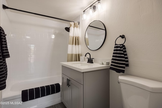 425 W Paseo Redondo Unit 3D, Tucson, AZ 85701 - bathroom featuring shower / bath combo with shower curtain, vanity, toilet, and a textured wall
