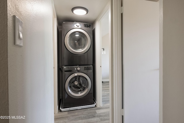 425 W Paseo Redondo Unit 3D, Tucson, AZ 85701 - washroom with stacked washer and clothes dryer and wood finished floors