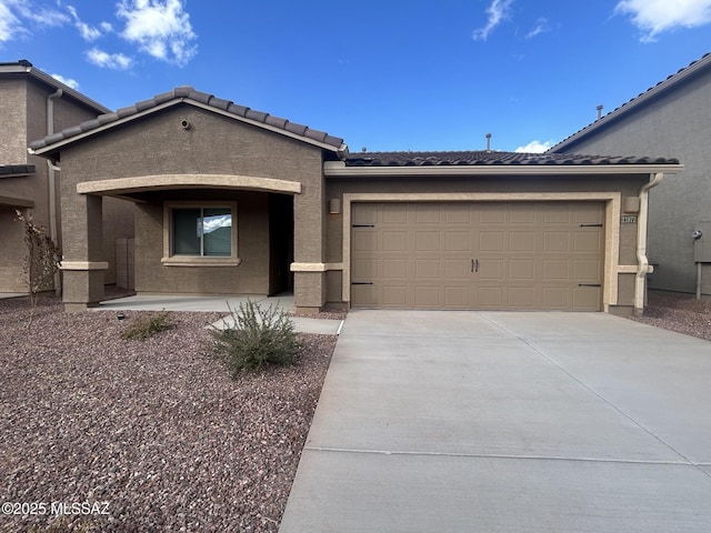 21972 E Wayward Ln, Red Rock, AZ 85145 - view of front facade with driveway, a garage, stucco siding, and a tiled roof