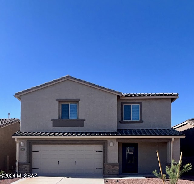 21984 E Wayward Ln, Red Rock, AZ 85145 - view of front of house featuring a garage, a tiled roof, driveway, and stucco siding