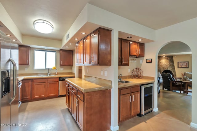 2435 N Shade Tree Cir, Tucson, AZ 85715 - kitchen featuring wine cooler, stainless steel appliances, a sink, brown cabinetry, and recessed lighting
