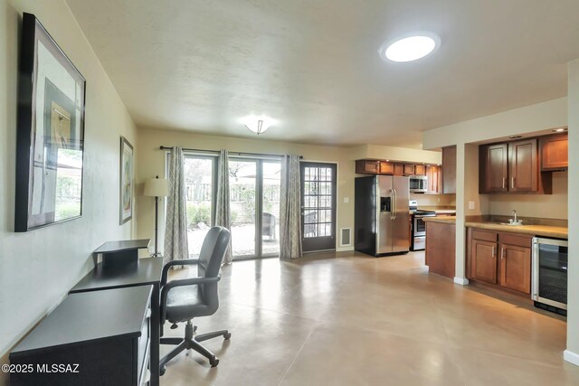 2435 N Shade Tree Cir, Tucson, AZ 85715 - office area featuring wine cooler, bar with sink, and baseboards