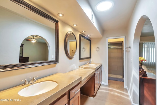 2435 N Shade Tree Cir, Tucson, AZ 85715 - full bath with double vanity, concrete floors, a ceiling fan, a tile shower, and recessed lighting