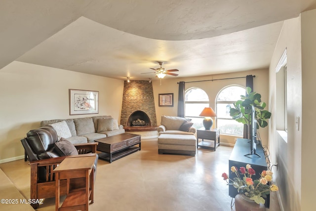 2435 N Shade Tree Cir, Tucson, AZ 85715 - living area with a ceiling fan, baseboards, concrete floors, and a large fireplace