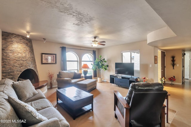 2435 N Shade Tree Cir, Tucson, AZ 85715 - living room featuring plenty of natural light, a ceiling fan, and baseboards