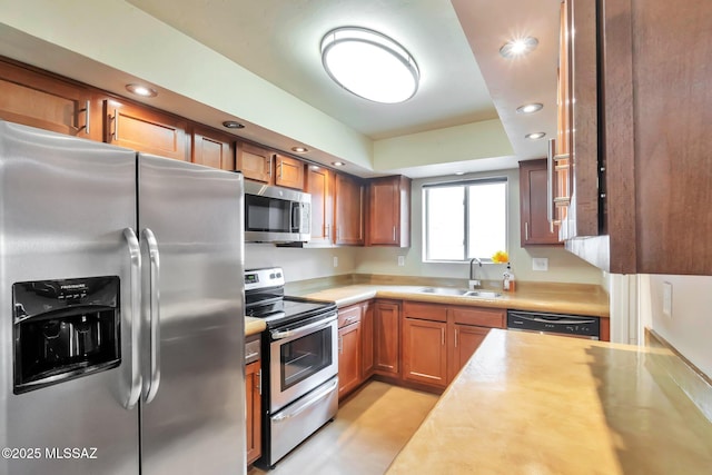 2435 N Shade Tree Cir, Tucson, AZ 85715 - kitchen with stainless steel appliances, a sink, light countertops, recessed lighting, and brown cabinets