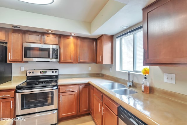2435 N Shade Tree Cir, Tucson, AZ 85715 - kitchen with appliances with stainless steel finishes, a sink, light countertops, brown cabinets, and recessed lighting