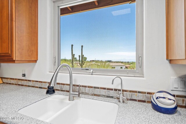 6731 N Pontatoc Rd, Tucson, AZ 85718 - detailed view of a sink, light countertops, and brown cabinetry