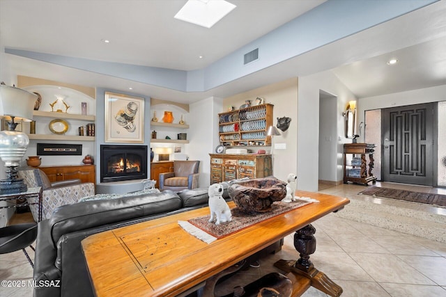 6731 N Pontatoc Rd, Tucson, AZ 85718 - living area featuring a glass covered fireplace, built in features, tile patterned floors, and a skylight