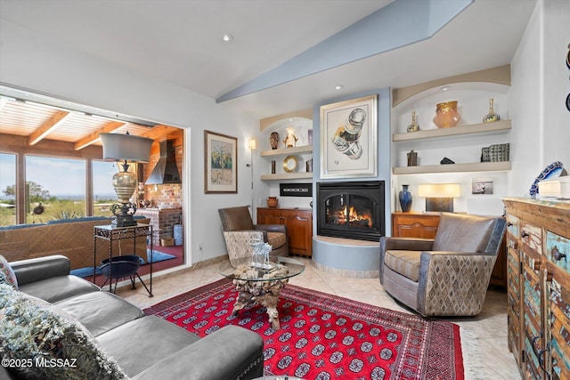 6731 N Pontatoc Rd, Tucson, AZ 85718 - living area with a glass covered fireplace, vaulted ceiling, built in shelves, and light tile patterned flooring