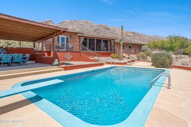 6731 N Pontatoc Rd, Tucson, AZ 85718 - outdoor pool with a diving board, a deck with mountain view, a patio area, stairway, and a sunroom