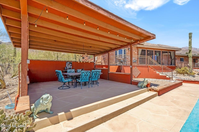 6731 N Pontatoc Rd, Tucson, AZ 85718 - view of patio featuring a sunroom, stairs, and outdoor dining area
