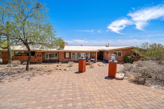6731 N Pontatoc Rd, Tucson, AZ 85718 - rear view of property with brick siding