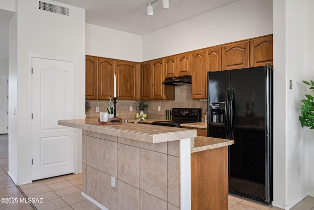 246 W Tabascoe Pl, Oro Valley, AZ 85755 - kitchen featuring black appliances, under cabinet range hood, light tile patterned floors, and light countertops