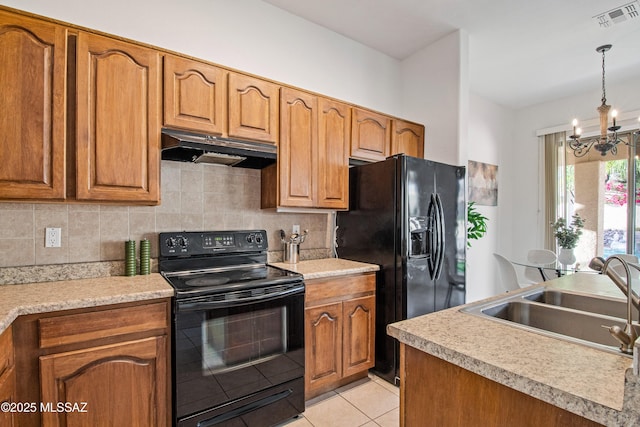 246 W Tabascoe Pl, Oro Valley, AZ 85755 - kitchen with black appliances, under cabinet range hood, a sink, a chandelier, and brown cabinetry