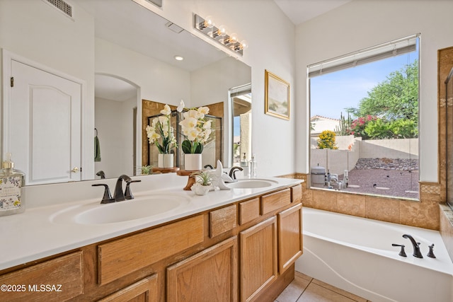 246 W Tabascoe Pl, Oro Valley, AZ 85755 - bathroom featuring double vanity, a bath, and tile patterned flooring