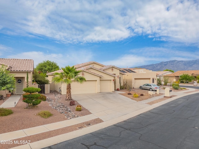246 W Tabascoe Pl, Oro Valley, AZ 85755 - view of front of home with stucco siding, a garage, concrete driveway, and a mountain view