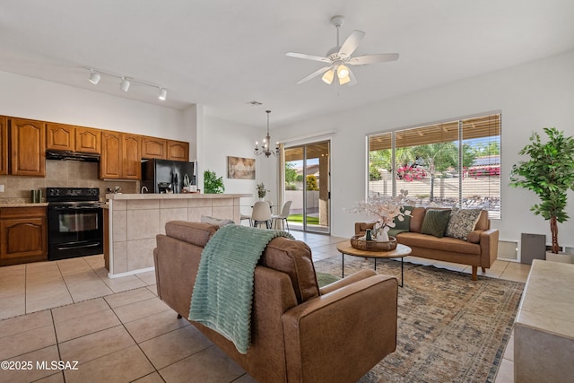 246 W Tabascoe Pl, Oro Valley, AZ 85755 - living room featuring light tile patterned flooring, ceiling fan, and a chandelier