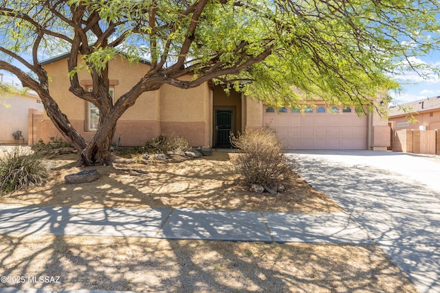 3347 S Desert Scroll Pl, Tucson, AZ 85735 - view of front of house with stucco siding, driveway, and an attached garage