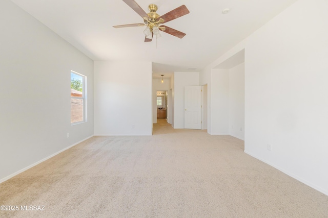 3347 S Desert Scroll Pl, Tucson, AZ 85735 - spare room featuring light colored carpet, ceiling fan, and baseboards