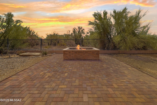 3347 S Desert Scroll Pl, Tucson, AZ 85735 - patio terrace at dusk with an outdoor fire pit and a patio area