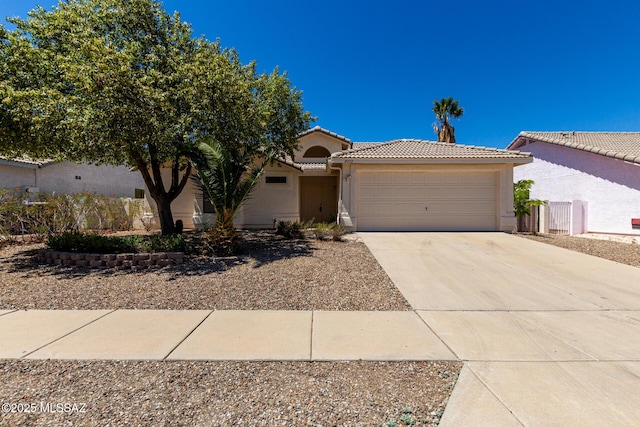 8072 S Carbury Way, Tucson, AZ 85747 - view of front of house featuring a tile roof, stucco siding, an attached garage, and concrete driveway
