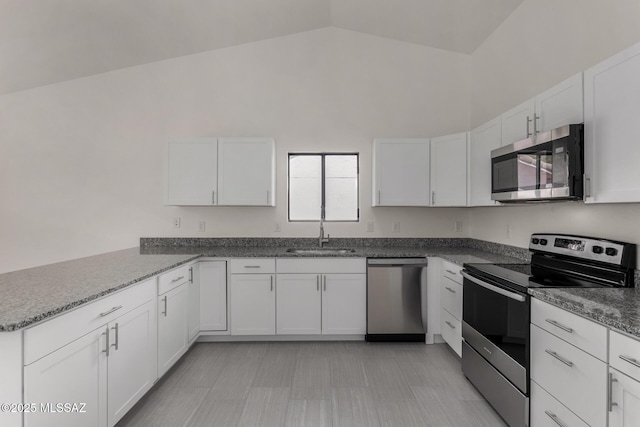 8072 S Carbury Way, Tucson, AZ 85747 - kitchen with appliances with stainless steel finishes, a sink, white cabinetry, a peninsula, and high vaulted ceiling