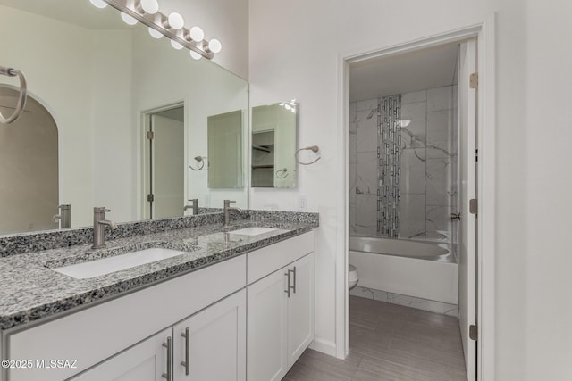 8072 S Carbury Way, Tucson, AZ 85747 - full bath featuring toilet, double vanity, washtub / shower combination, and baseboards