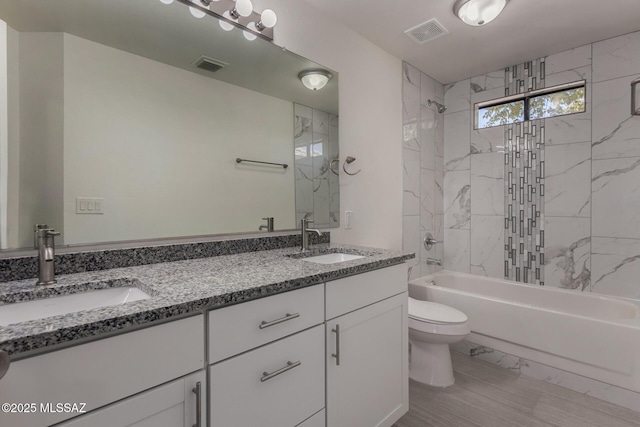 8072 S Carbury Way, Tucson, AZ 85747 - full bathroom featuring toilet, double vanity, and washtub / shower combination