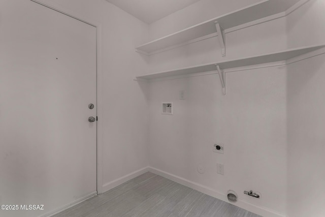 8072 S Carbury Way, Tucson, AZ 85747 - laundry room featuring hookup for a gas dryer, hookup for a washing machine, light wood-type flooring, electric dryer hookup, and baseboards