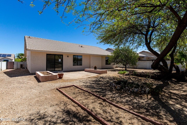 8072 S Carbury Way, Tucson, AZ 85747 - back of house featuring a tile roof, a fenced backyard, a patio, and stucco siding