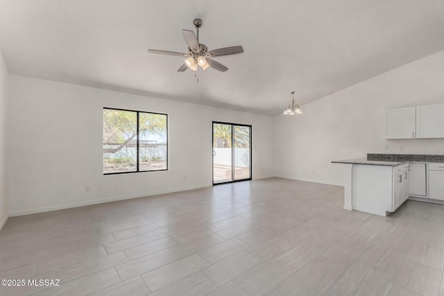 8072 S Carbury Way, Tucson, AZ 85747 - unfurnished living room with ceiling fan, lofted ceiling, a chandelier, and baseboards