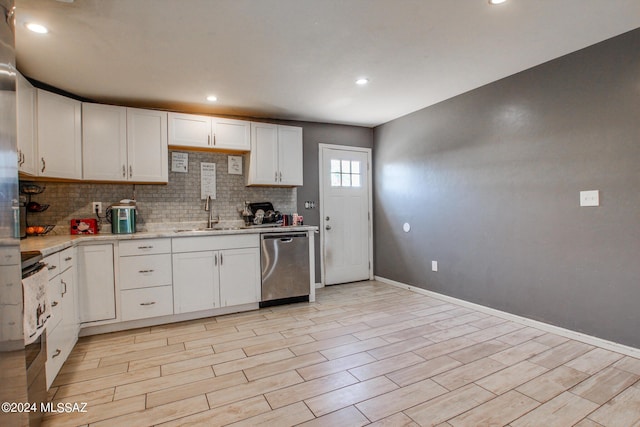 3758 E Ellington Pl, Tucson, AZ 85713 - kitchen with dishwasher, a sink, tasteful backsplash, baseboards, and white cabinets