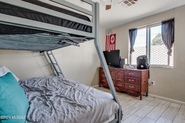 3758 E Ellington Pl, Tucson, AZ 85713 - bedroom featuring baseboards, wood tiled floors, and ceiling fan