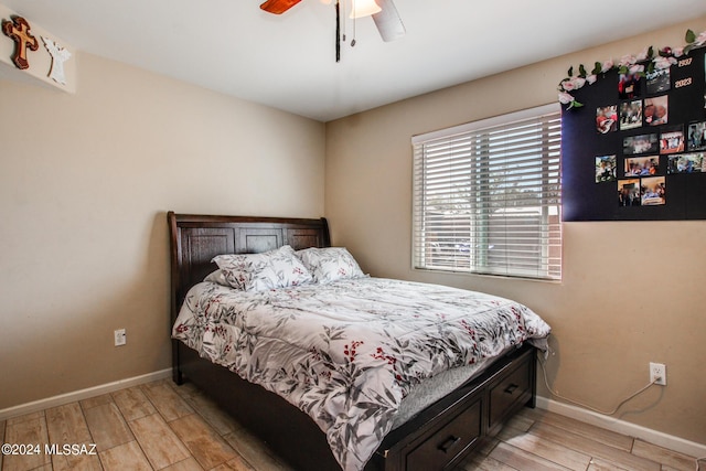 3758 E Ellington Pl, Tucson, AZ 85713 - bedroom with light wood finished floors, baseboards, and ceiling fan