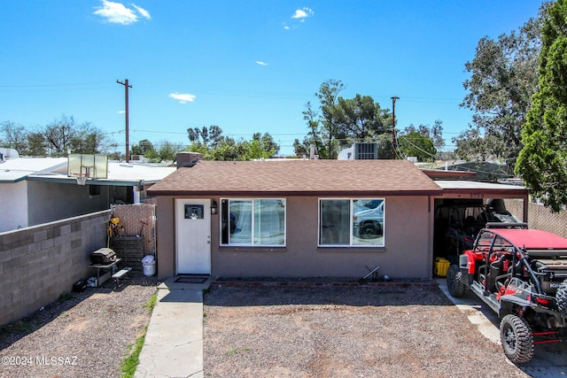 3758 E Ellington Pl, Tucson, AZ 85713 - view of front of home with stucco siding, a shingled roof, and an attached carport