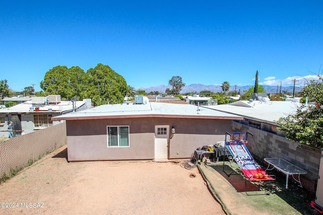 3758 E Ellington Pl, Tucson, AZ 85713 - back of house with a fenced backyard, a mountain view, and cooling unit