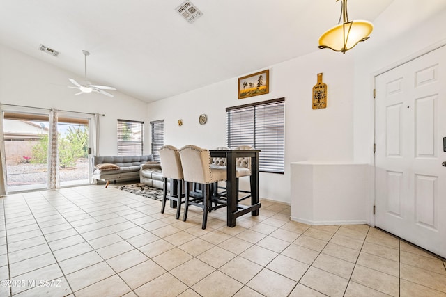 9504 N Englewood Dr, Tucson, AZ 85743 - dining area featuring lofted ceiling, light tile patterned floors, a ceiling fan, and baseboards