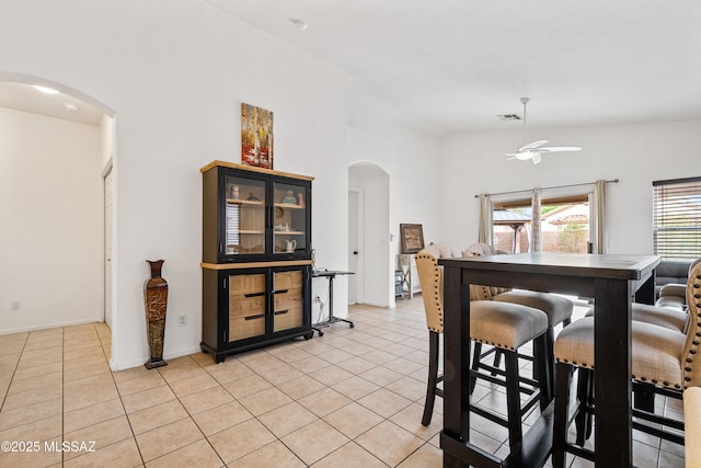 9504 N Englewood Dr, Tucson, AZ 85743 - dining room with arched walkways, a ceiling fan, and light tile patterned floors