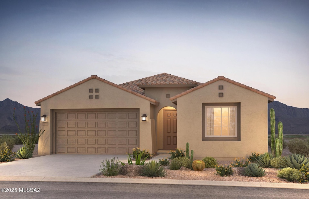 13313 N Galena Trl, Oro Valley, AZ 85755 - mediterranean / spanish home featuring a garage, concrete driveway, stucco siding, and a mountain view