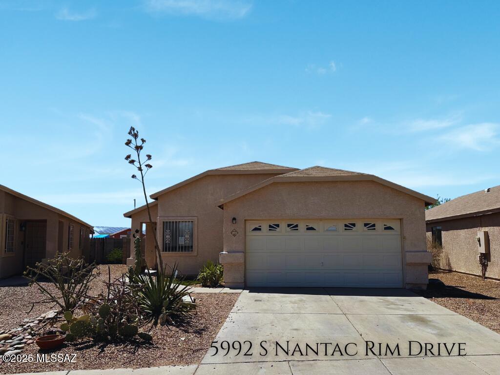 5992 S Nantec Rim Dr, Tucson, AZ 85706 - single story home featuring stucco siding, a garage, and driveway