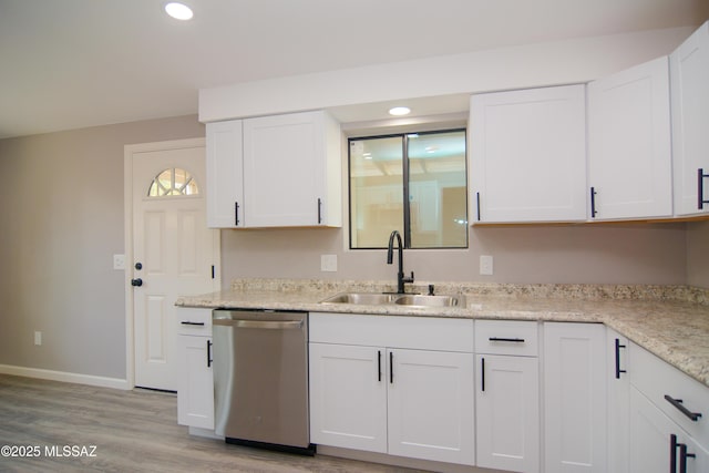 1321 W Saint Clair St, Tucson, AZ 85745 - kitchen with dishwasher, a sink, light wood-style floors, white cabinets, and baseboards