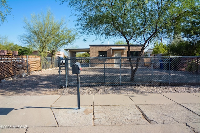 1321 W Saint Clair St, Tucson, AZ 85745 - view of front facade featuring brick siding, a fenced front yard, and a gate